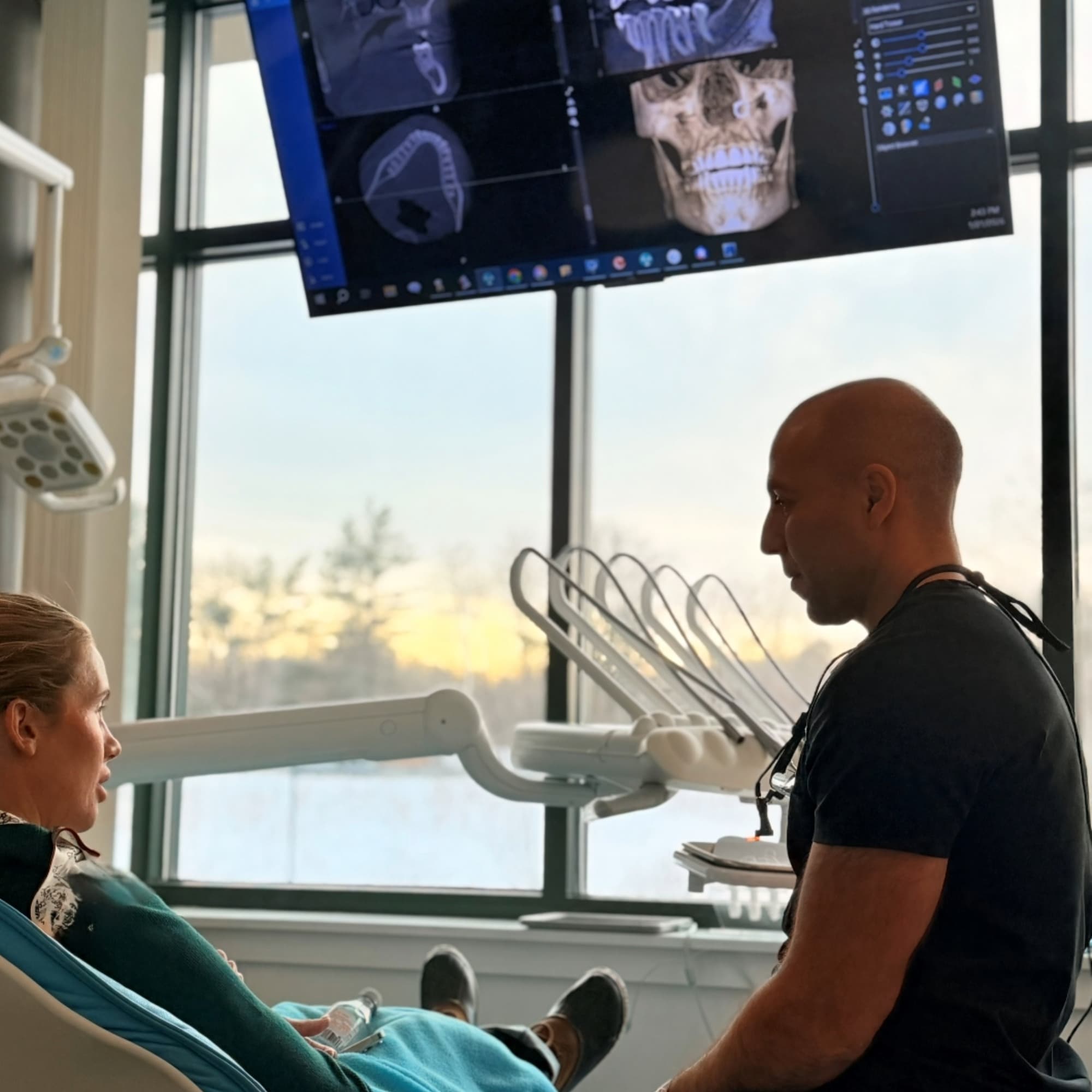 Dr. May consulting with a patient
